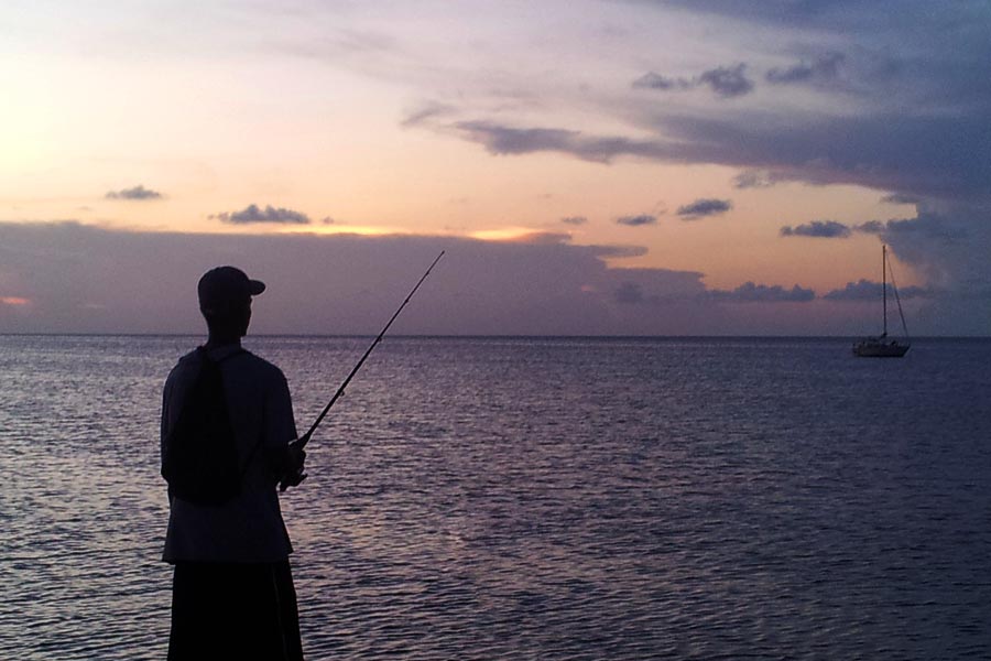 A local fishing at the pier in Caye Caulker, Belize