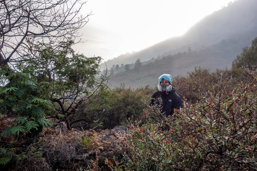 Ben with gas mask on top of Mount Ijen