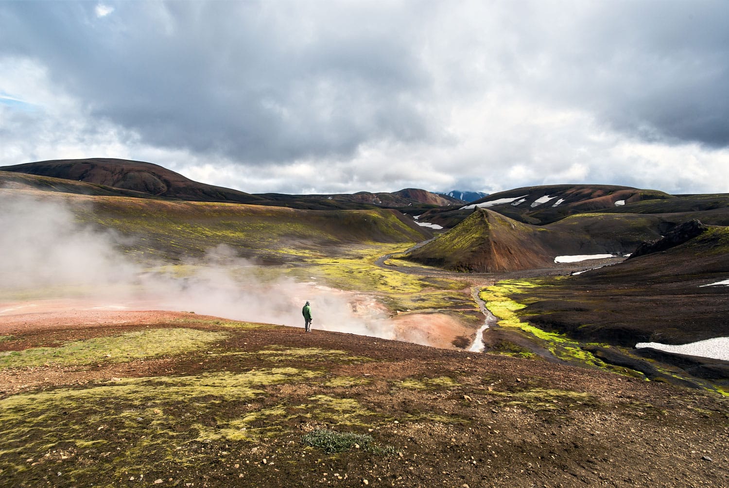 Hiking trail Landmannalaugar-Thorsmork "Laugavegur" in July in Iceland among mountains and volcanic ash with clouds of vapour