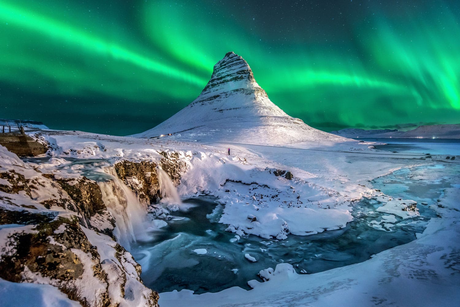 Northern lights appear over Mount Kirkjufell in Iceland.
