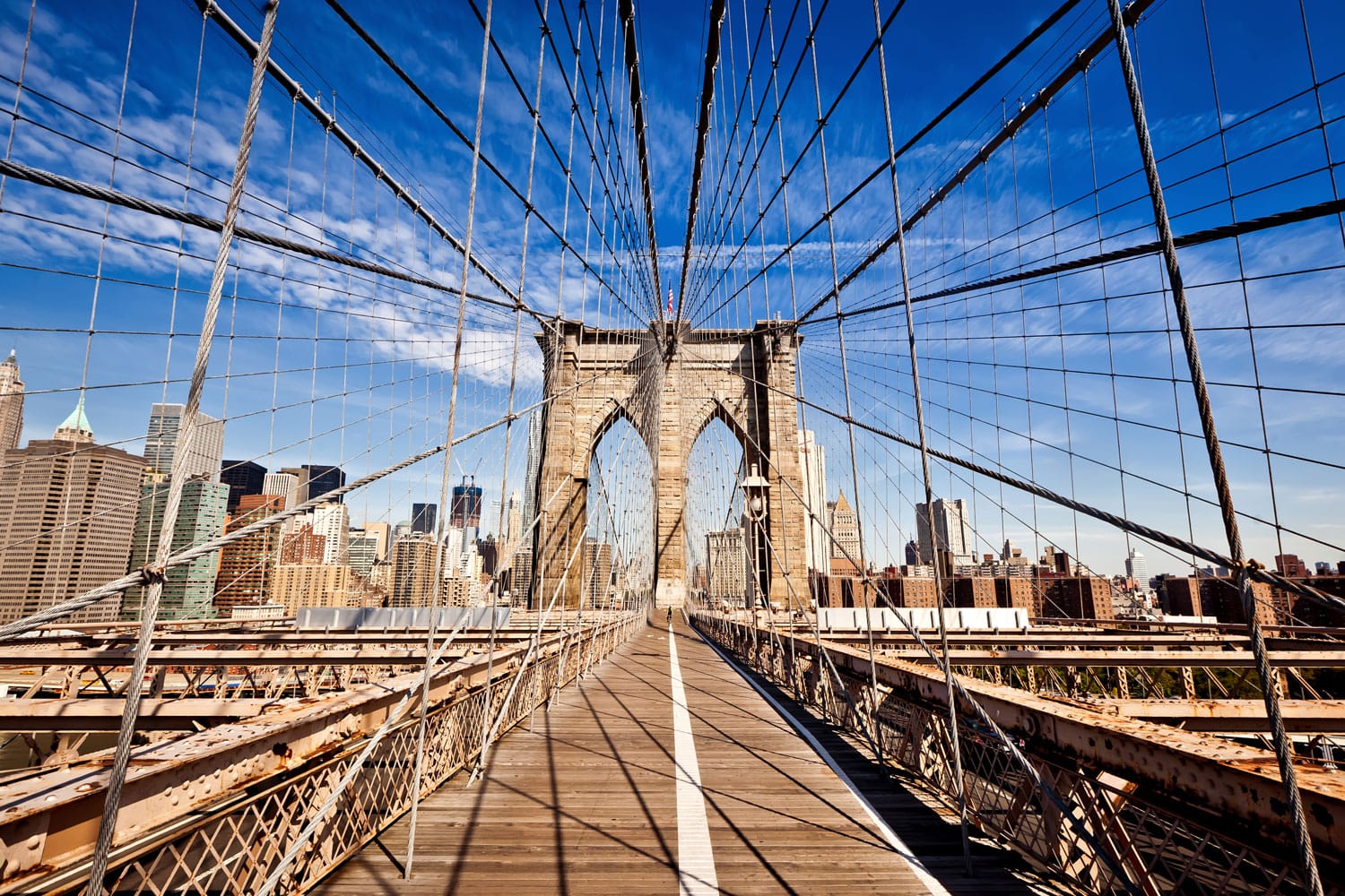 New York City Brooklyn Bridge in Manhattan closeup with skyscrapers and city skyline over Hudson River