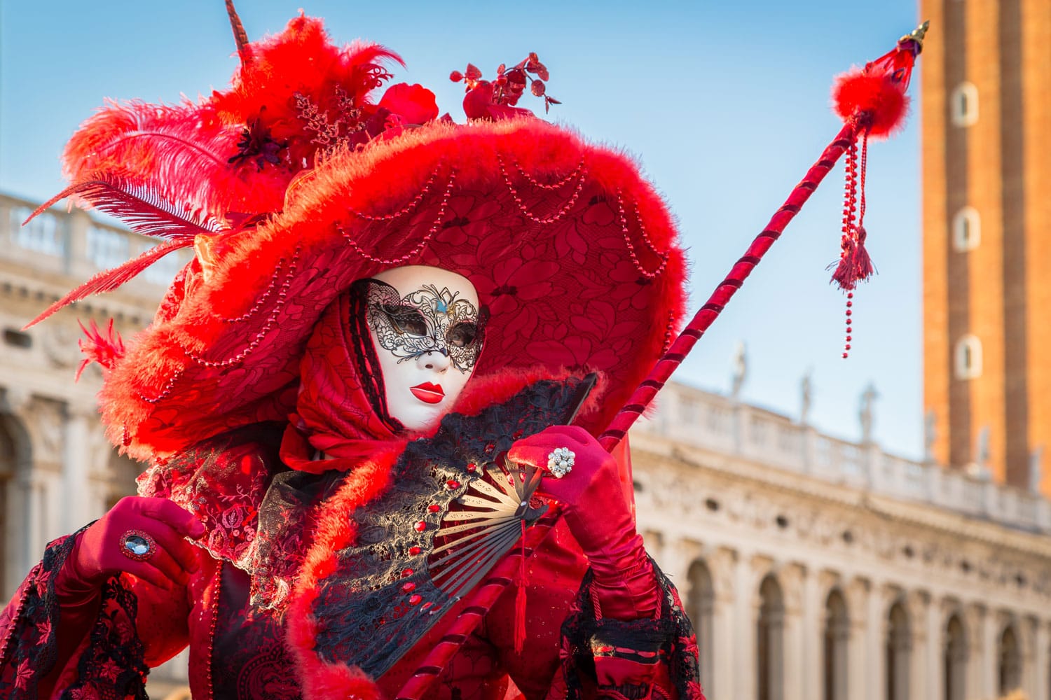 Person in a carnival costume attends the end Carnival of Venice in Venice, Italy