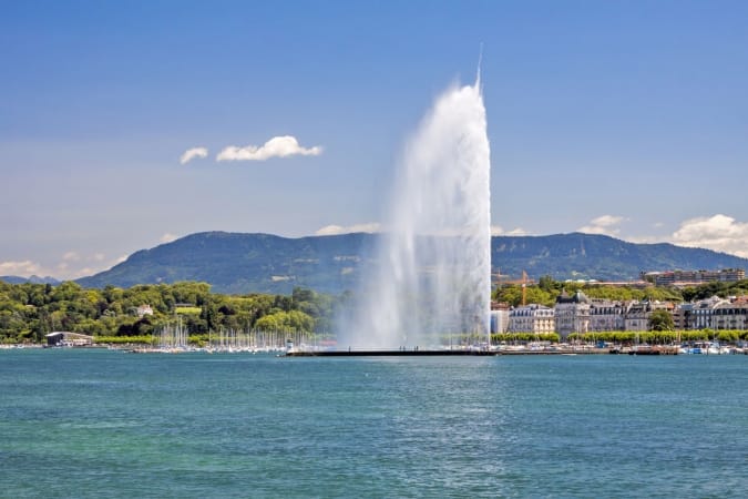 Panorama of the southern Lake Geneva shore and of the famous jet d'eau (water jet) fontain in Canton Geneva, Switzerland