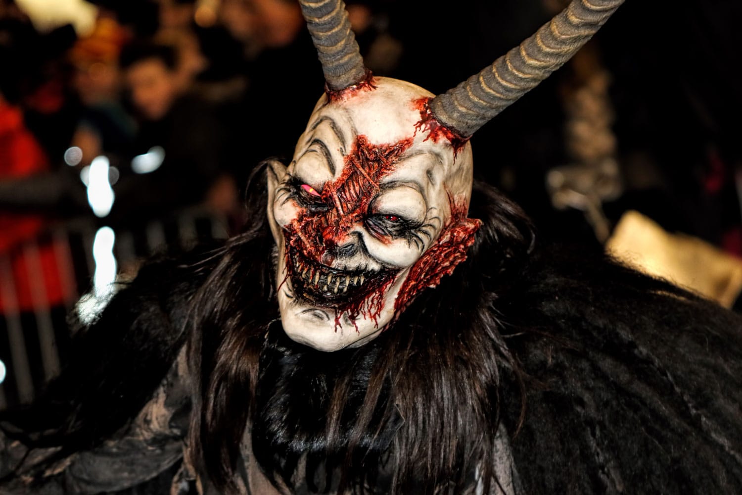 Person wearing an evil mask at Krampuslauf in Graz, Austria