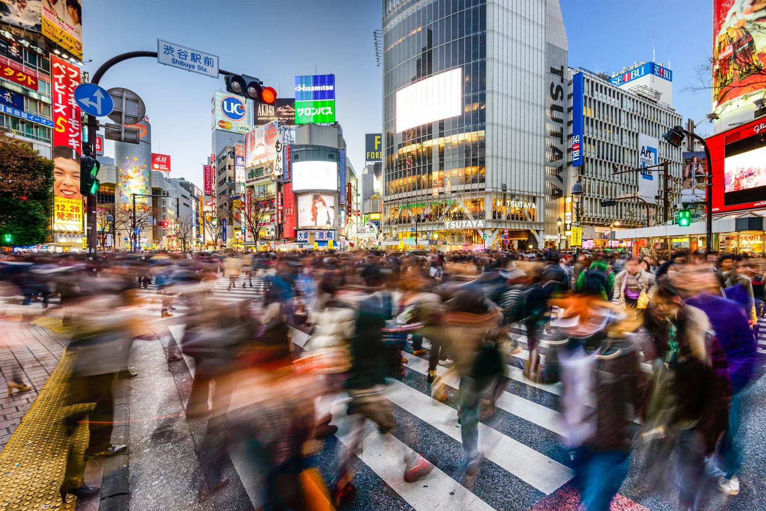 Pedestrians walk at Shibuya Crossing in Tokyo, Japan