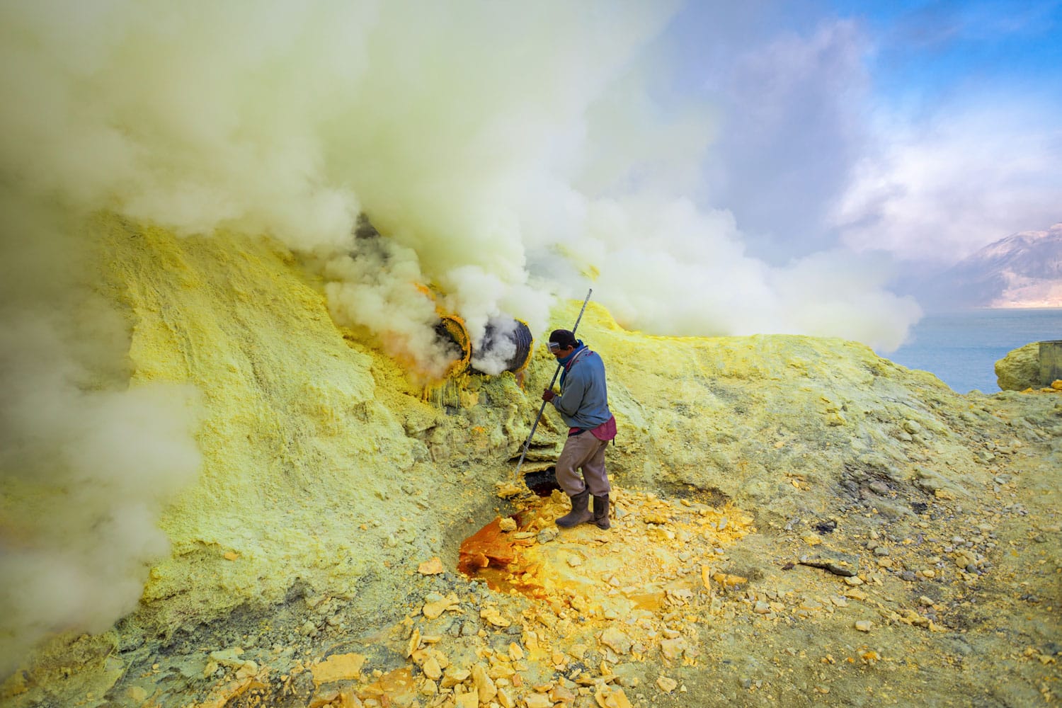 Sulfur miners inside crater Ijen volcano crater, Banyuwangi district, Indonesia