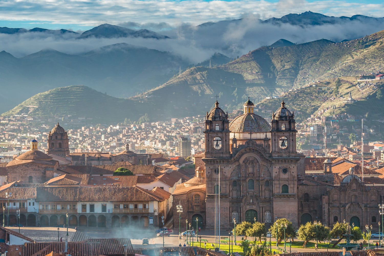 Morning sun rising at Plaza de armas with Adean Moutain and group of cloud, Cusco, Peru