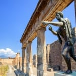 Ruins of the antique Temple of Apollo with bronze Apollo statue in Pompeii, Naples, Italy