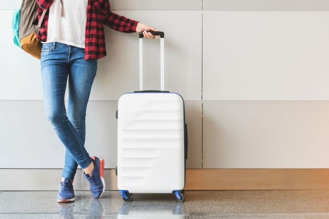 Young woman wearing casual clothes is posing at airport