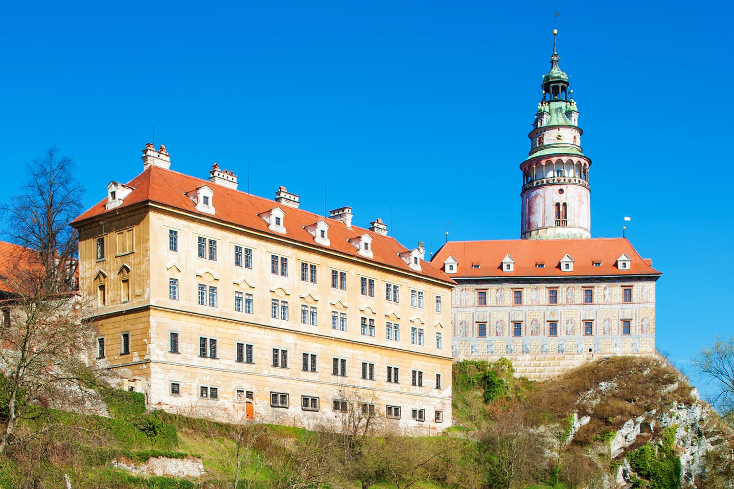 Castle with the famous round tower in Cesky Krumlov, Czech Republic is reflecting in the river Vltava