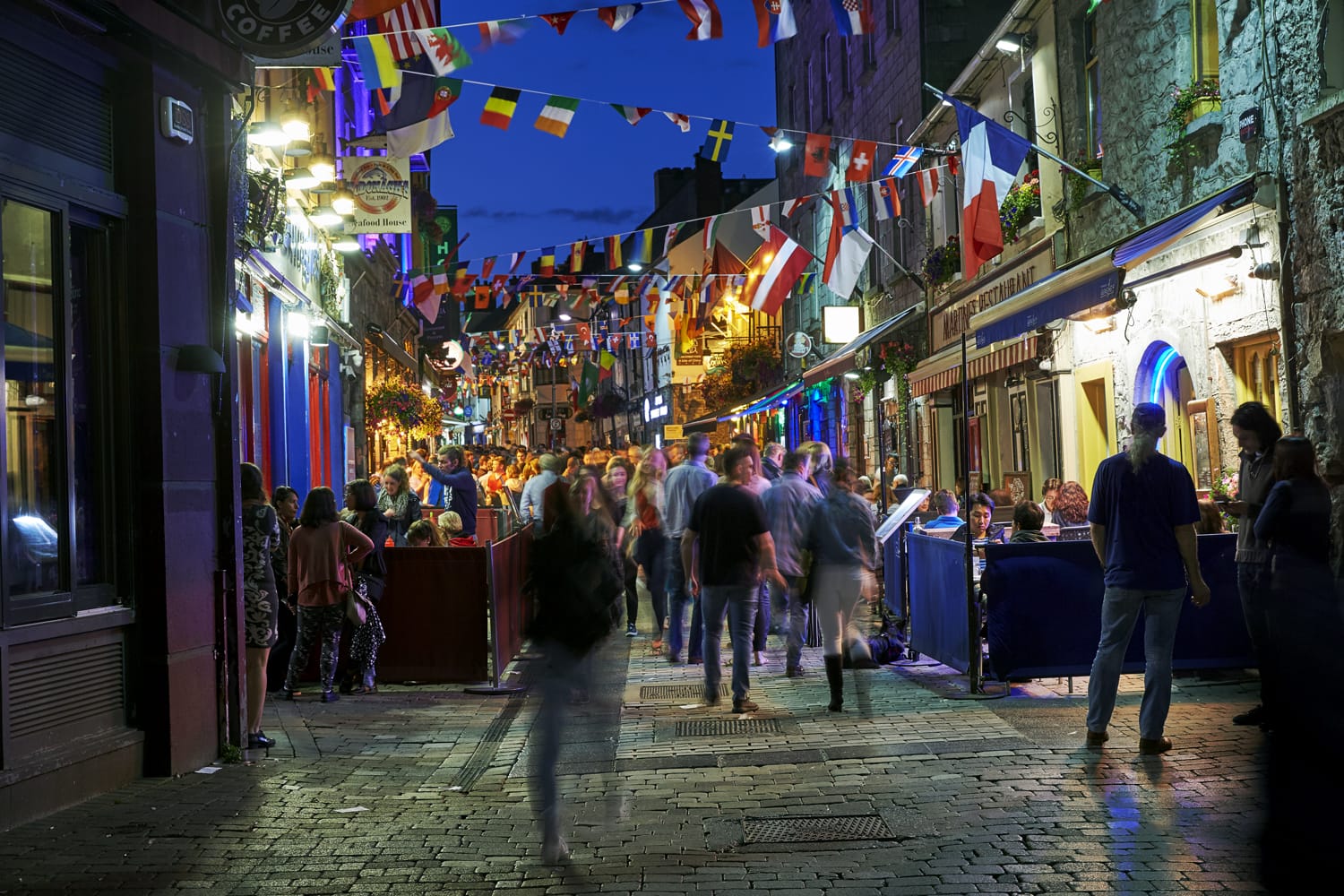 Vibrant cafe and bar culture in the city centre of Galway illuminated at night