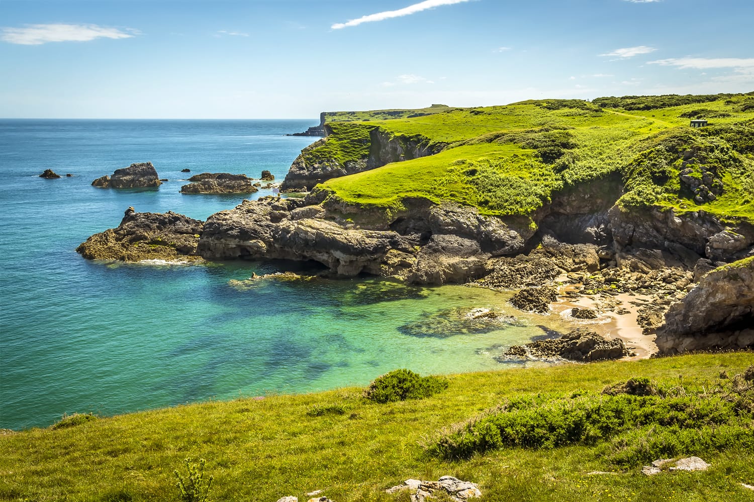 Turquoise sea at a secluded cove near Broad Haven on the Pembrokeshire coast in early summer