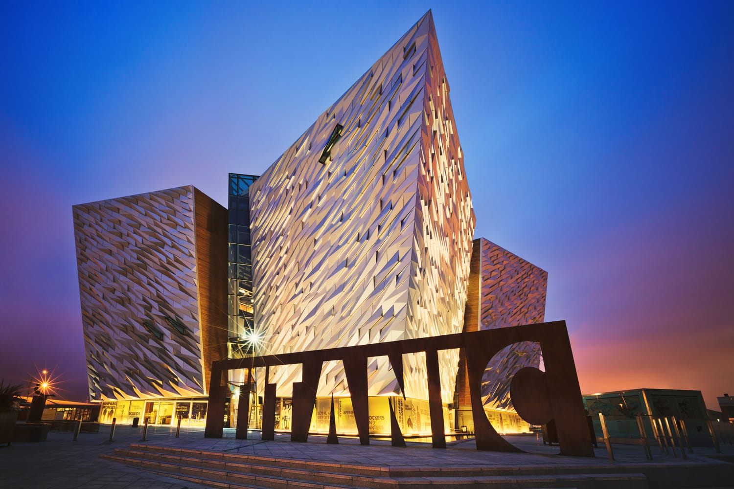 Sunset over Titanic Belfast - museum, touristic attraction and monument to Belfast's maritime heritage on the site of the former Harland and Wolff shipyard.