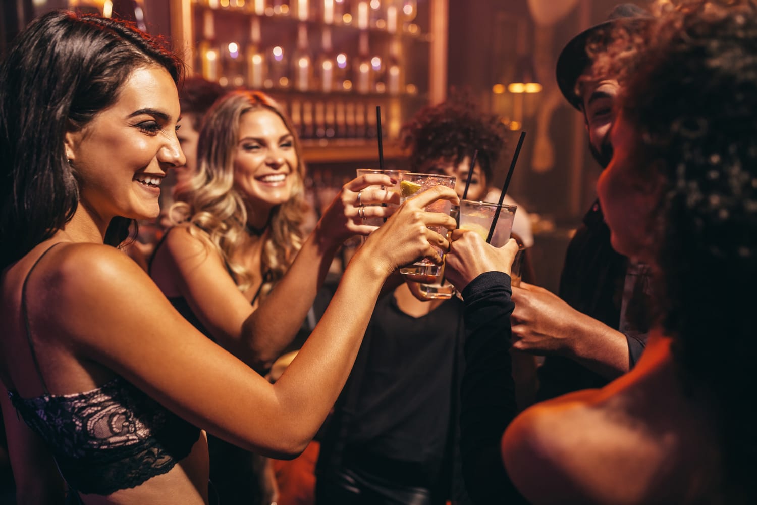 Group of young people with cocktails at nightclub