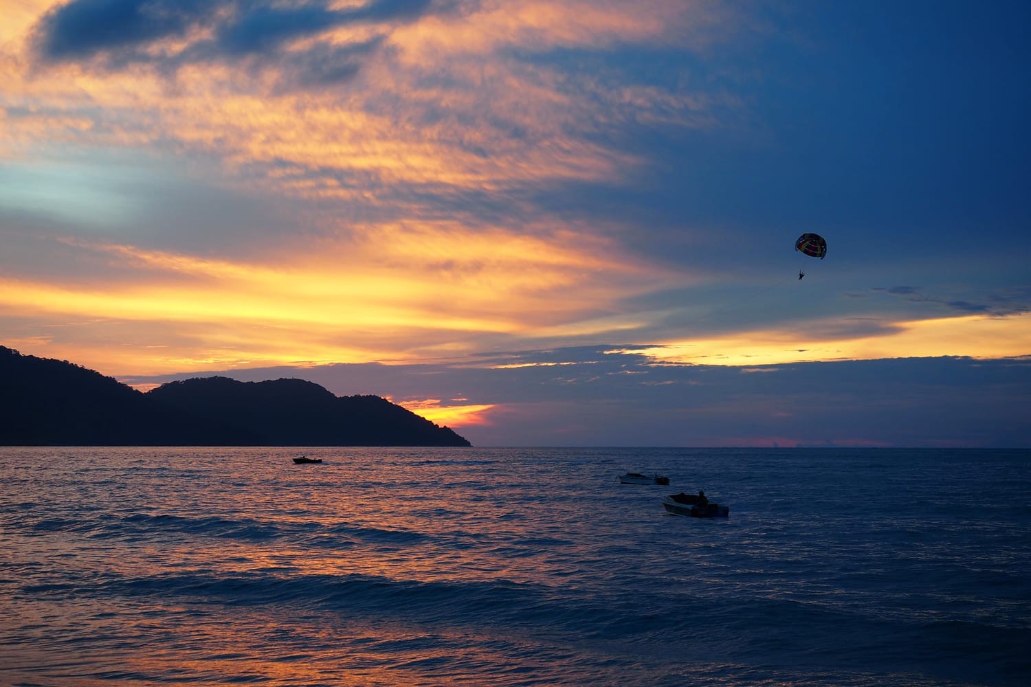 Parasailing with sunset background at Batu Ferringhi, Penang