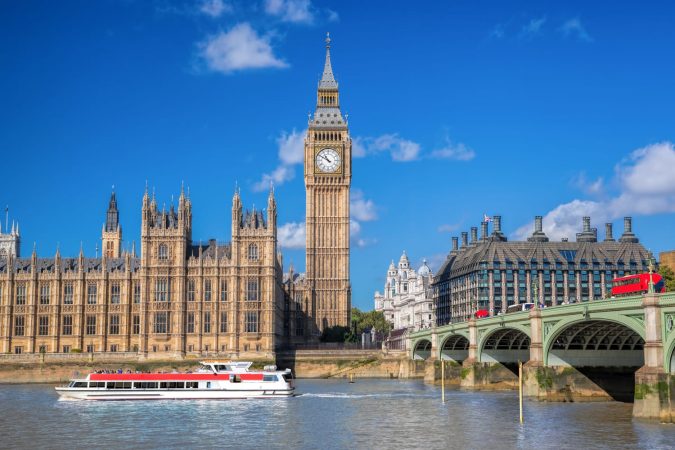 Big Ben and Houses of Parliament with boat in London, England, UK
