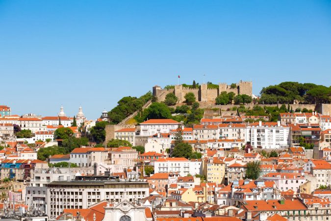 Cityscape of Lisbon, with Saint George Castle at the top of the mountain.