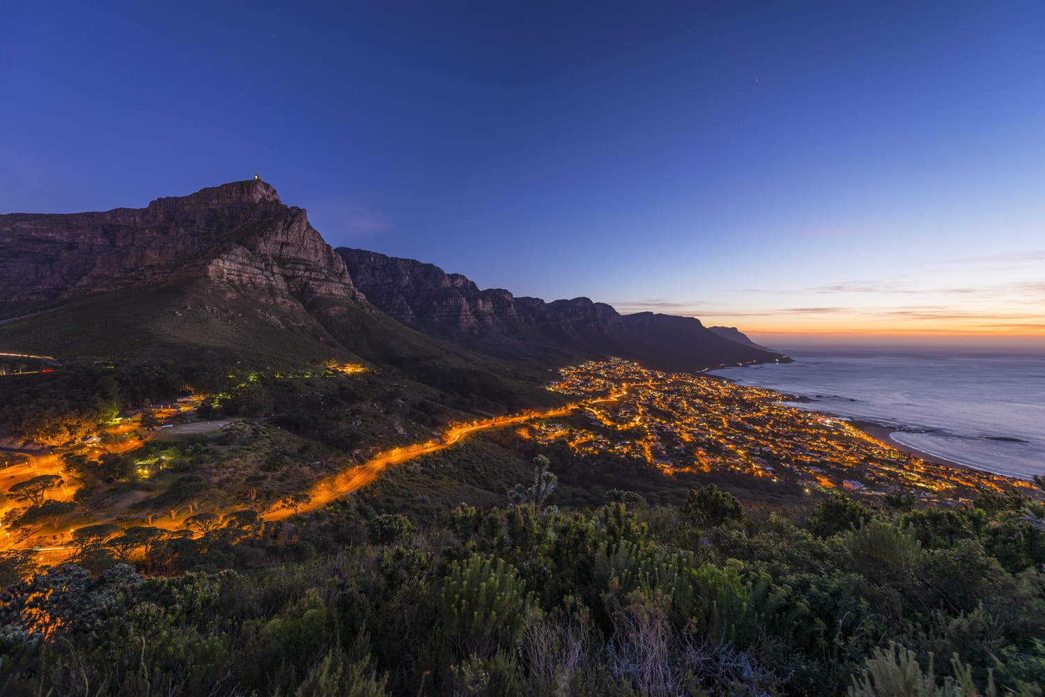 Cape Town's Table Mountain & Twelve Apostles seen from Lions Head hiking peak & Twelve Apostles with camps bay suburb and ocean below