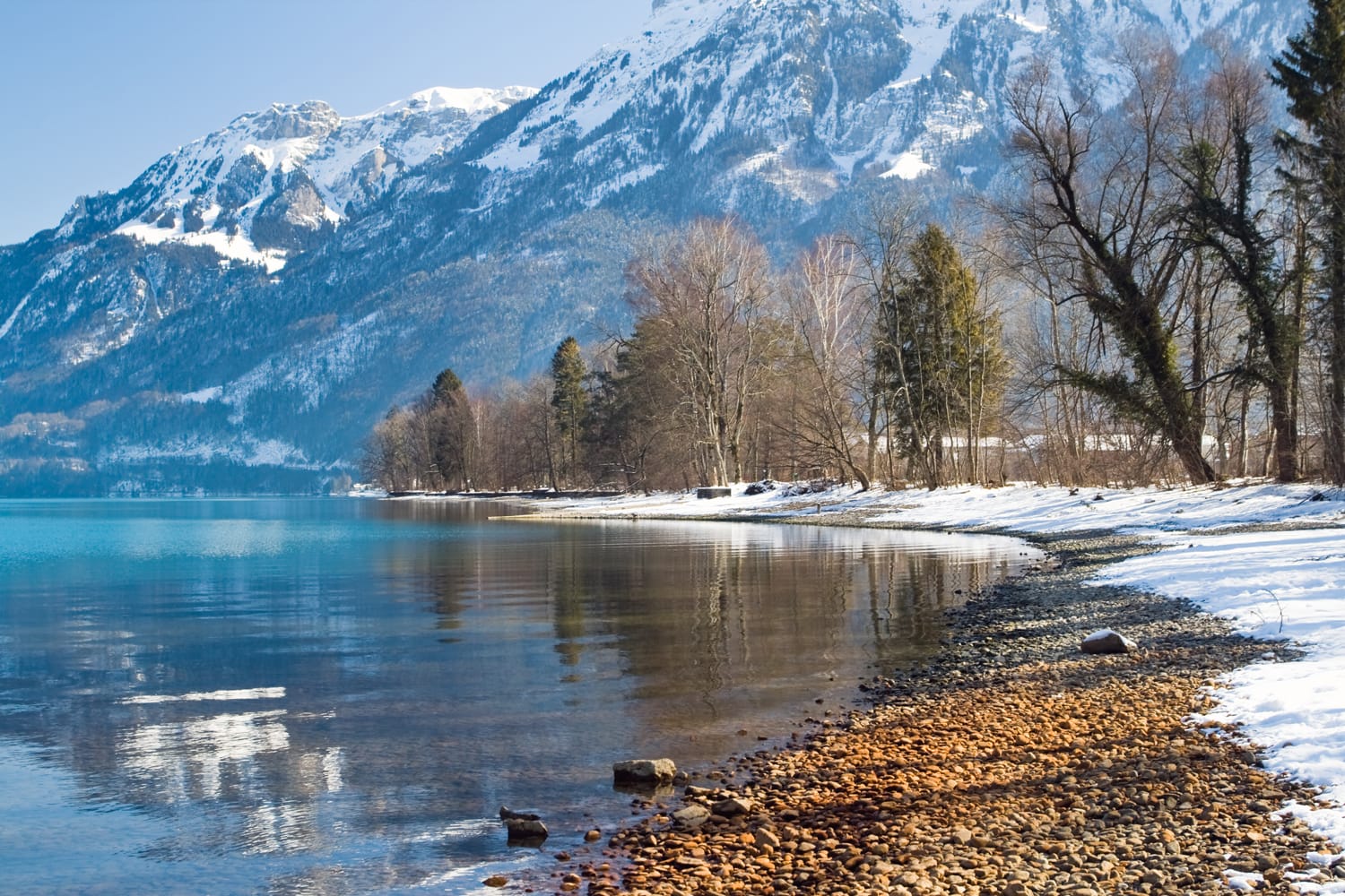 Horizontal image of the lake reflection on shore in the Alps with a blue background, Interlaken, Swiss.