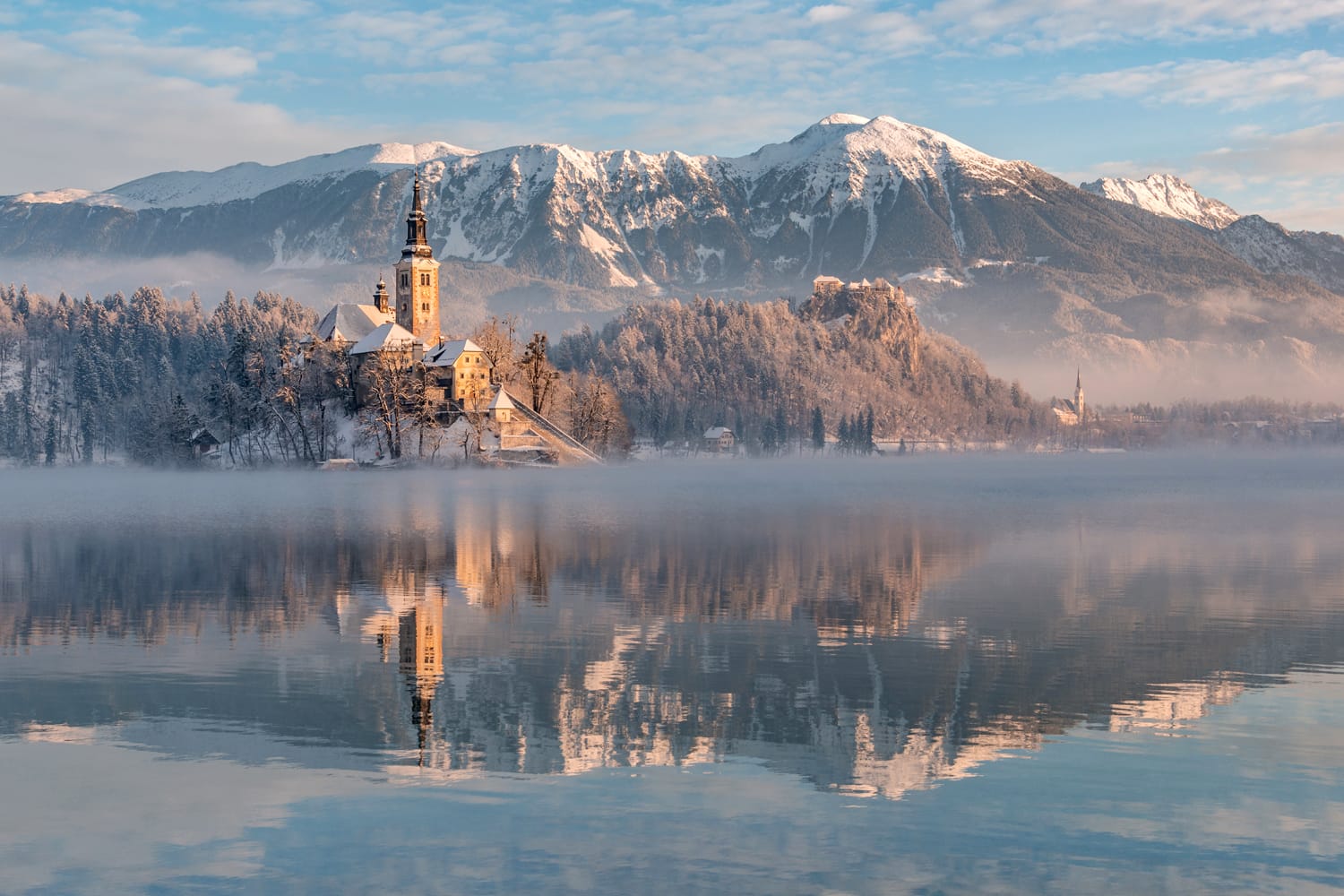 Lake Bled with the church and the castle on a calm winter morning