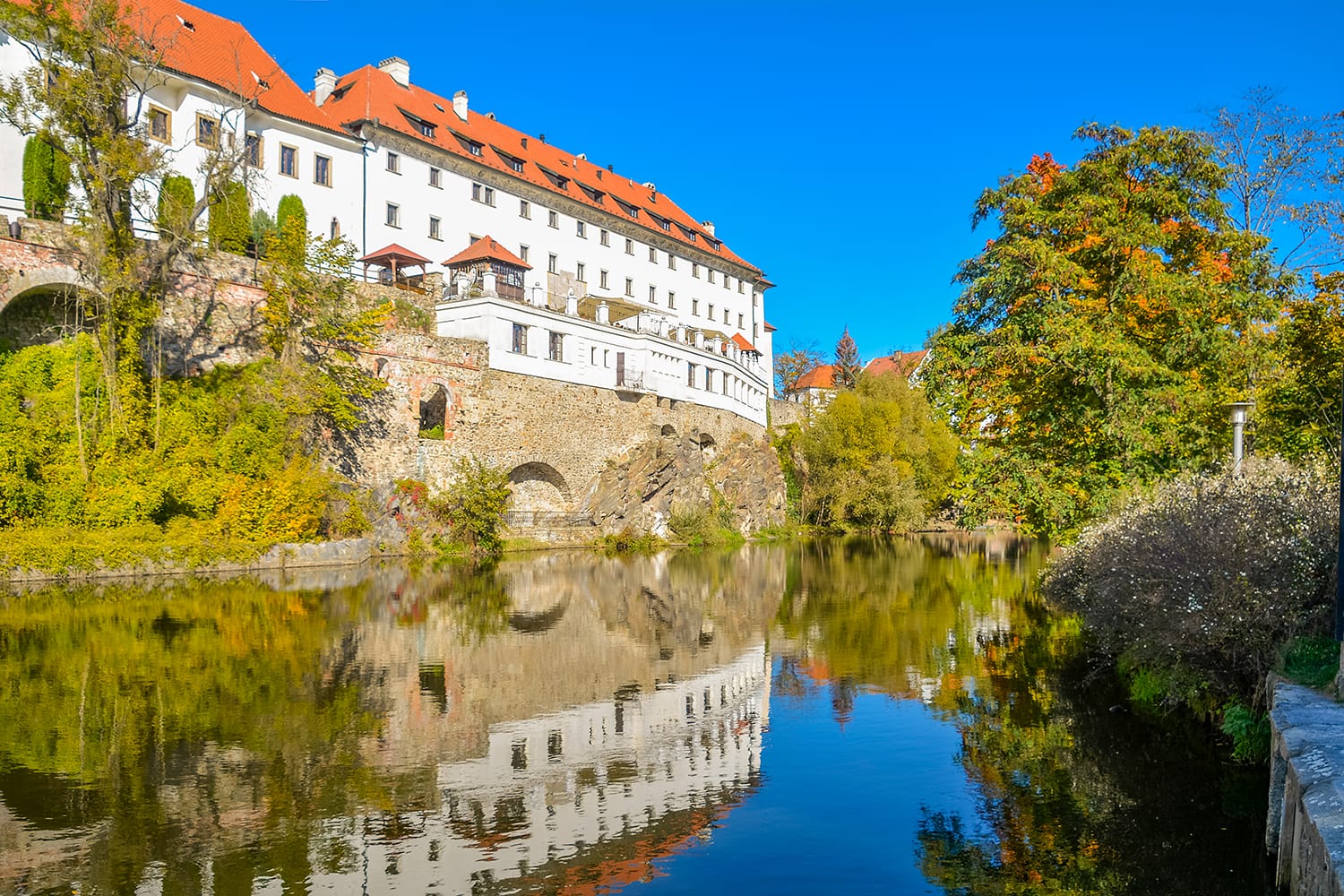 Embankment of Vltava River in Cesky Krumlov. Krumlov is town in South Bohemian Region of Czech Republic. Its historic centre, centred around Cesky Krumlov Castle.