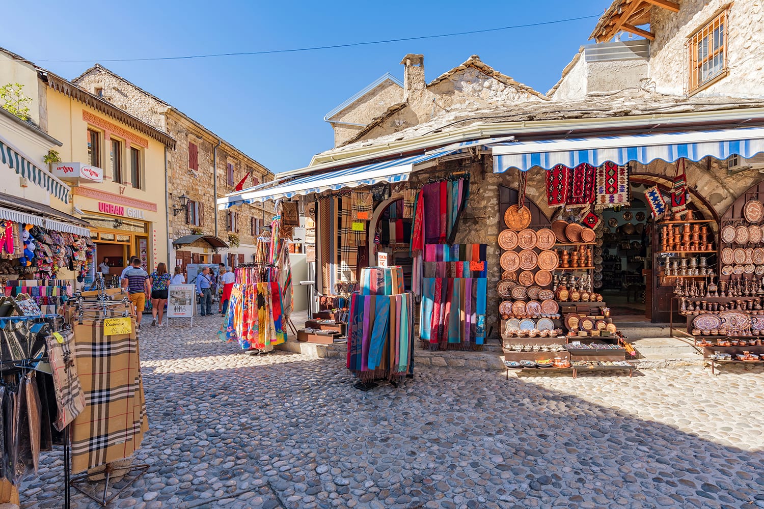 Mostar old town street with shops and historic architecture in Mostar