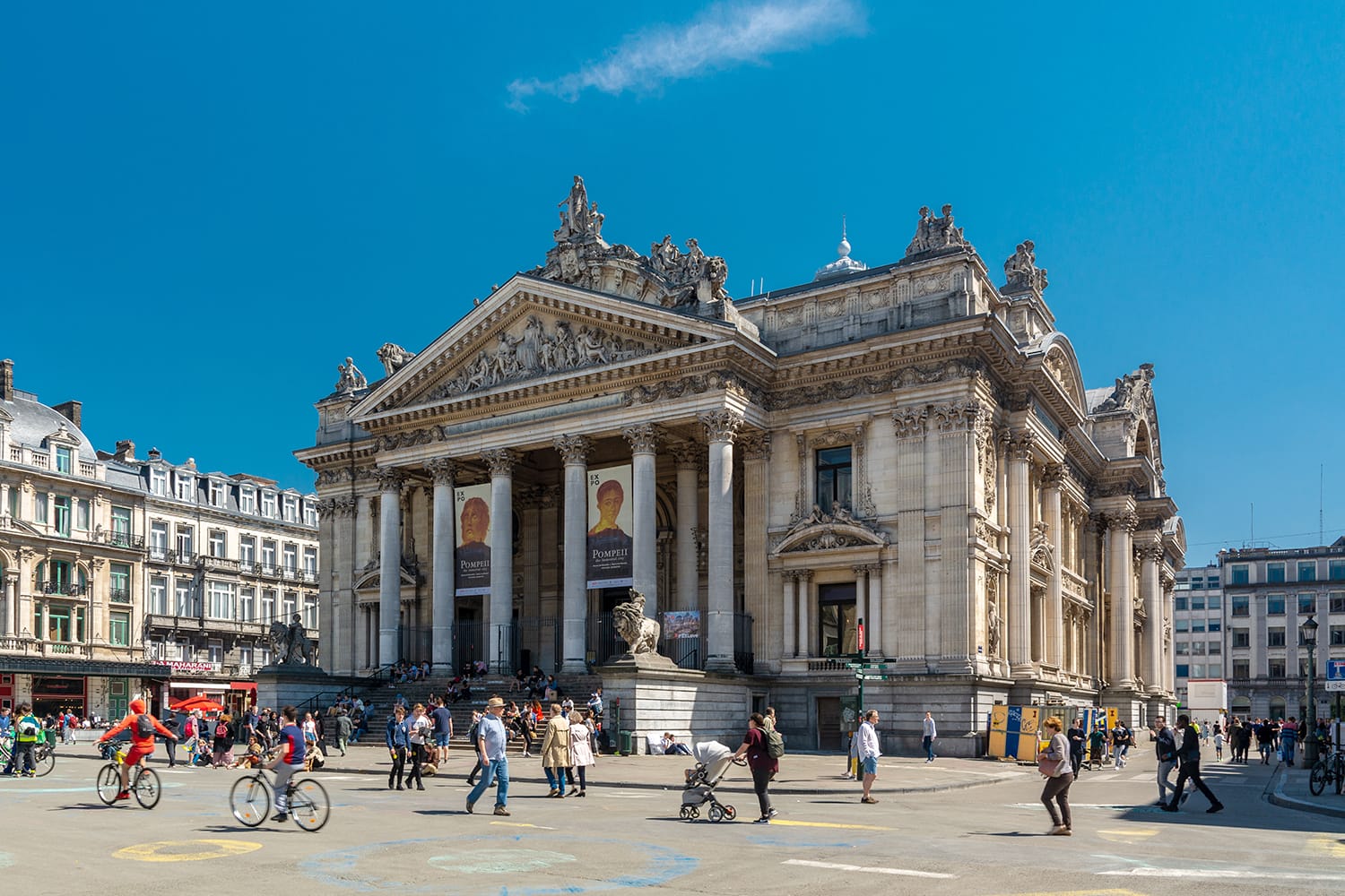 People walking on the pedestrian zone near the Brussels Stock Exchange. The building is usually called simply the Bourse and is located on Boulevard Anspach. Brussels, Belgium