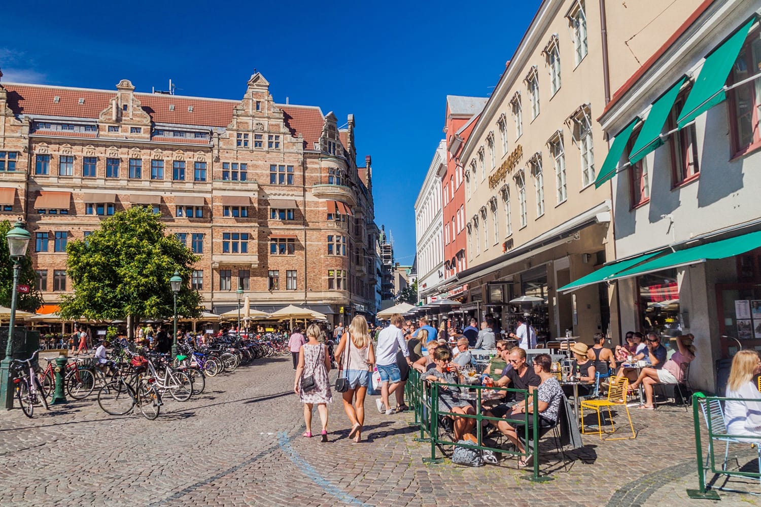 People enjoy a sunny day at Stortorget square in Malmo, Sweden
