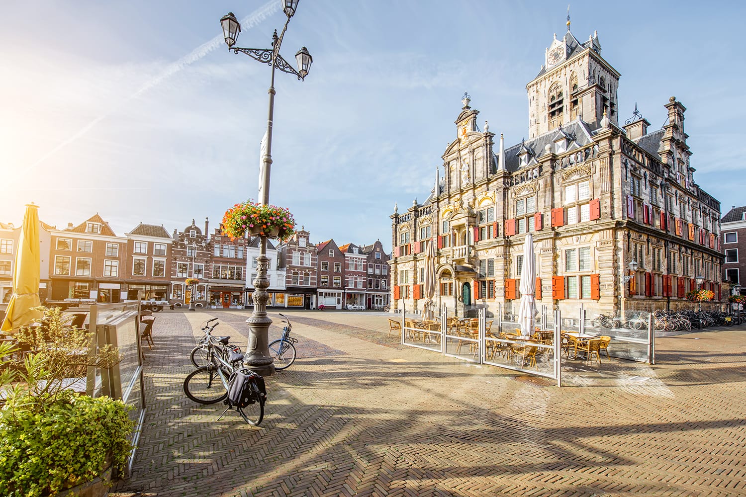View on the Town hall and beautiful buildings on the central square during the sunny morning in Delft city, Netherland
