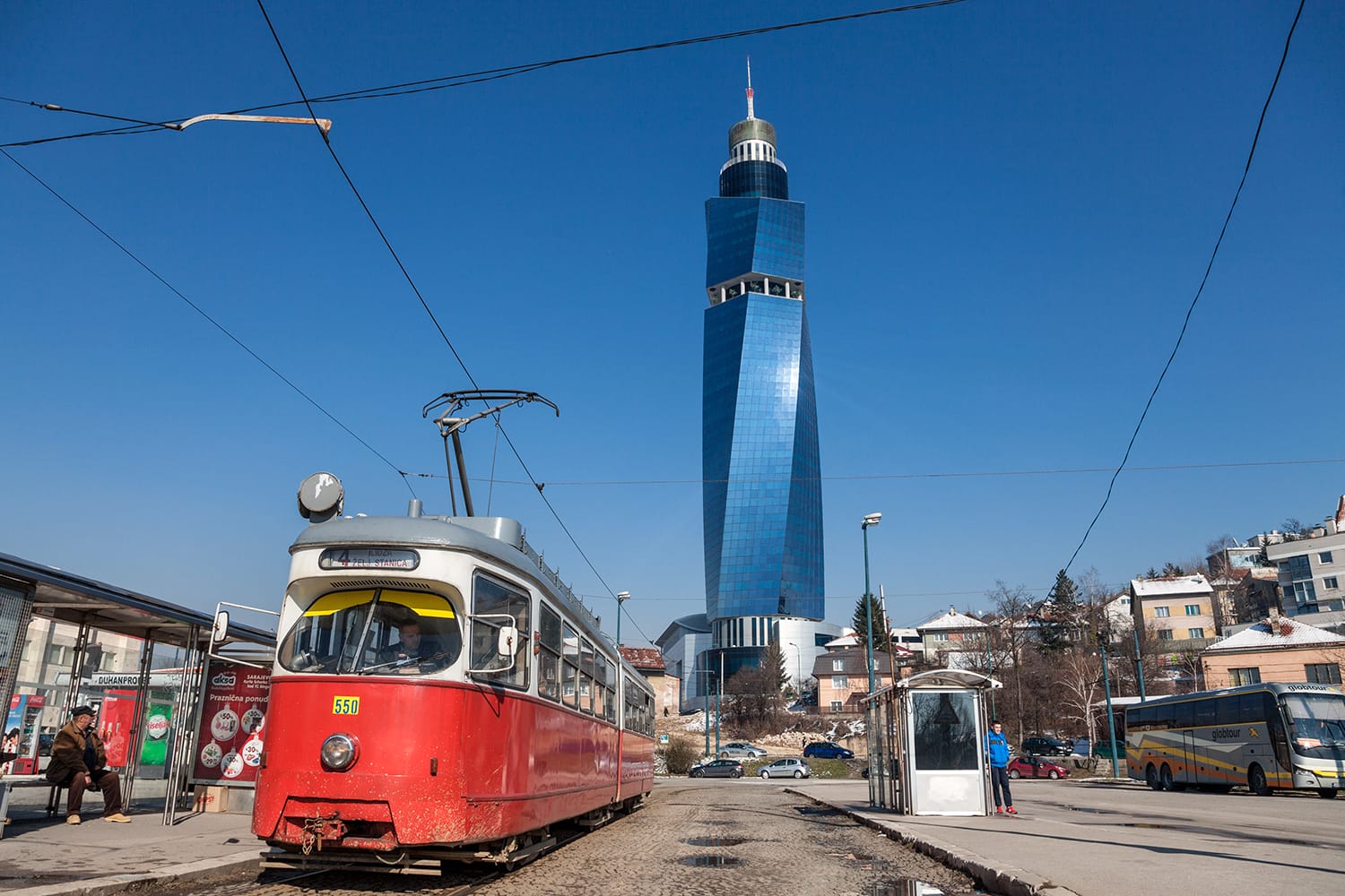 Tram ready for departure on the train station stop, the Avaz Twist Tower is seen in the background. Sarajevo, Bosnia & Herzegovina