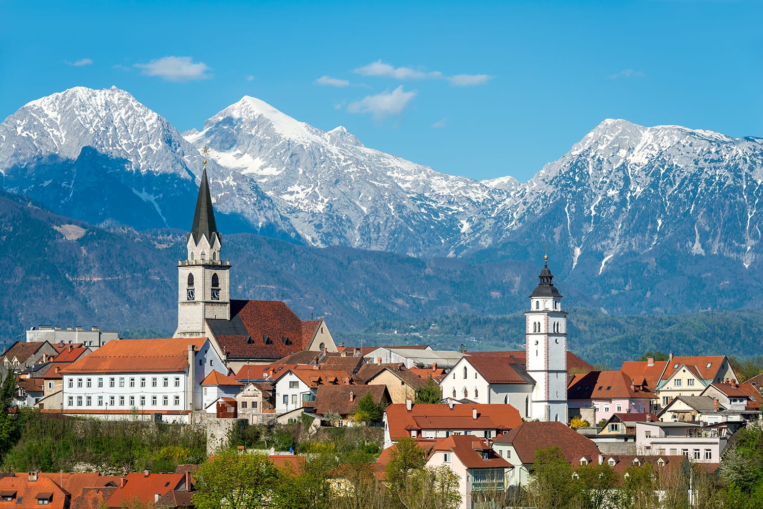 Panorama view Kranj in Slovenia with St. Cantianus Church in the foreground and the Kamnik Alps in the background