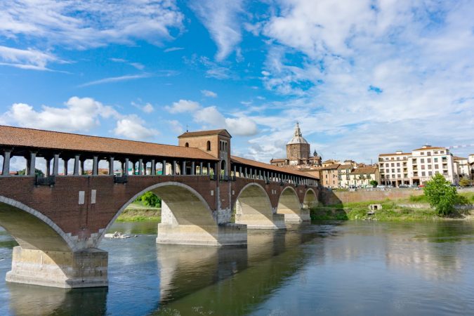 Ponte coperto ( covered bridge ) or Ponte Vecchio over Ticino river in Pavia, Lombardy, Italy