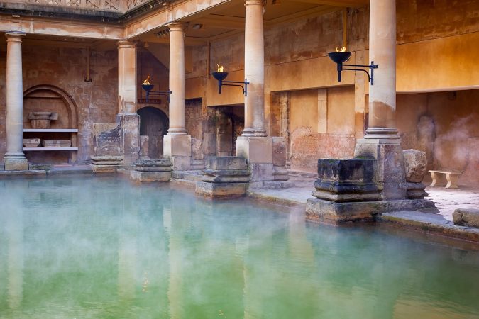 Steam rising off the hot mineral water in the Great Bath, part of the Roman Baths in Bath, UK