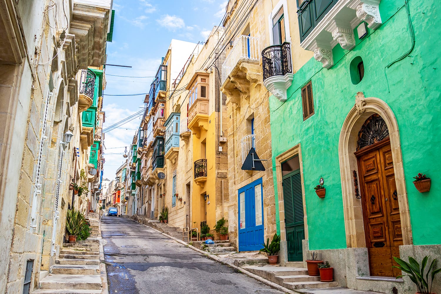 Beautiful colorful narrow lane with typical Maltese architecture in Cospicua - one of the Three fortified Cities of Malta