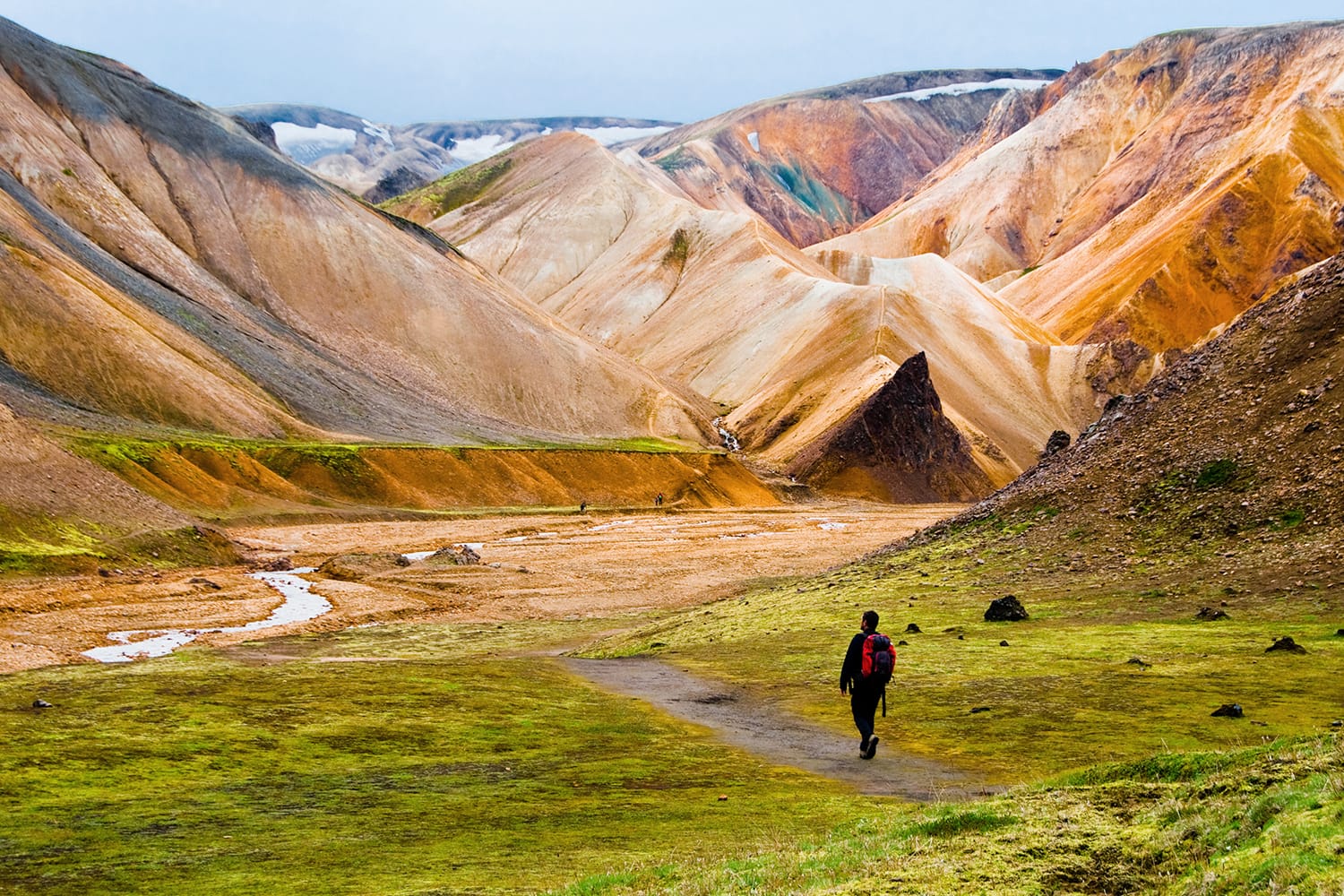 Person hiking at Landmannalaugar colorful mountains in Iceland