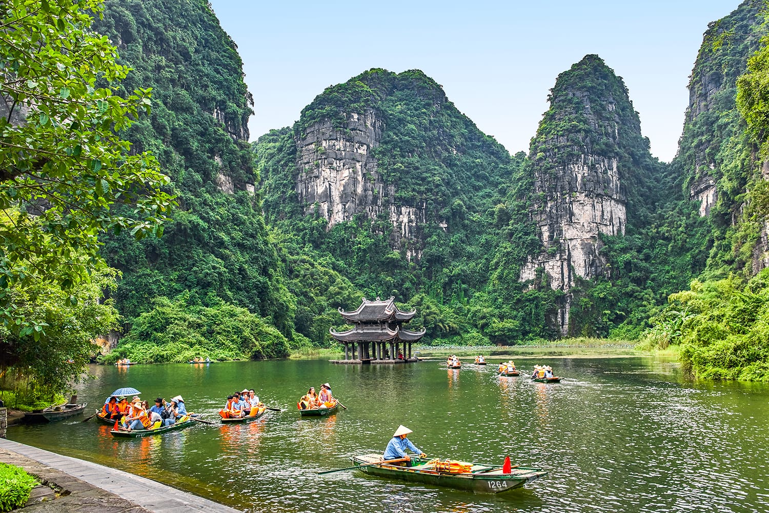 Rowboats with beautiful water temple view in Trang An, Ninh Binh, Vietnam