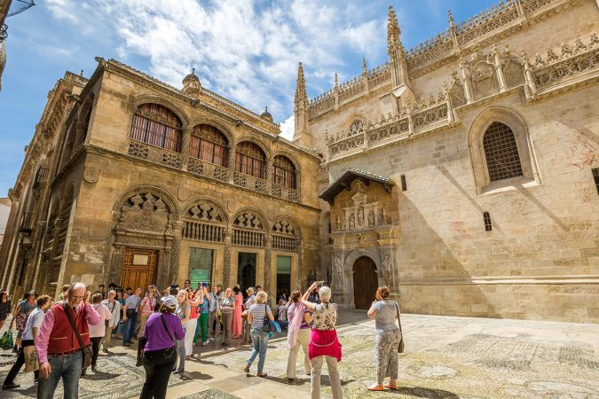 Tourists waiting time for afternoon opening of the Royal Chapel in Granada, Spain