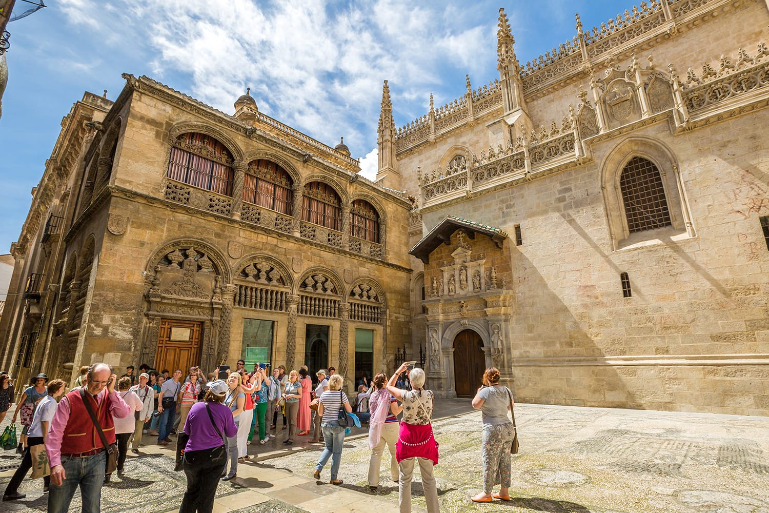 Tourists waiting time for afternoon opening of the Royal Chapel in Granada, Spain
