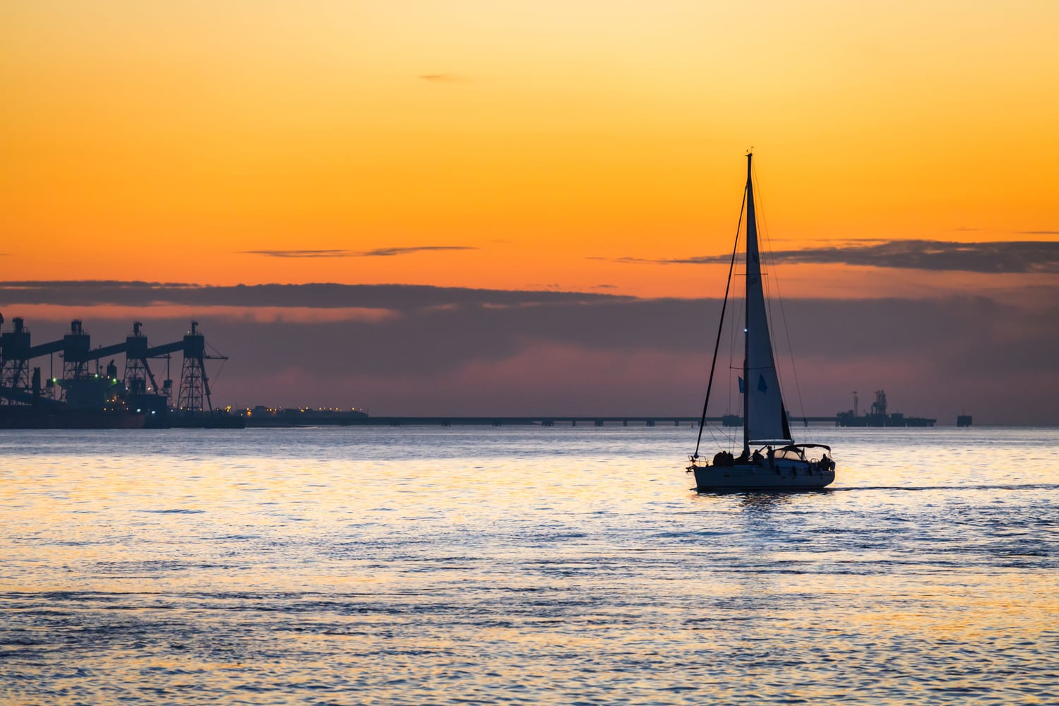 Luxury yacht Sailing on Tagus river at sunset in Lisbon, Portugal
