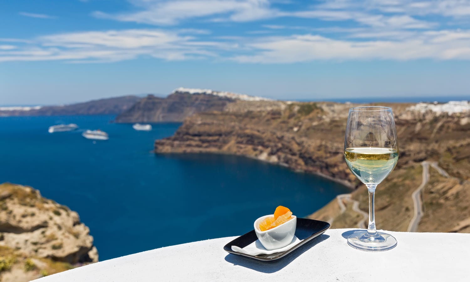 Wine glass with sea view in Santorini, Greece