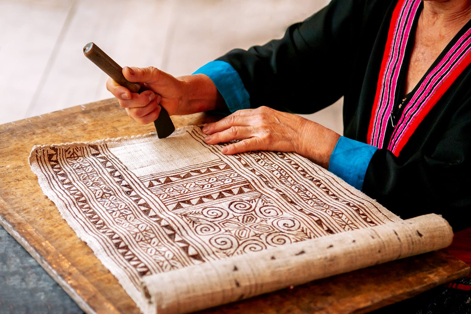 Hilltribe Laotian woman working on Batik fabric painting. Culture tourism at Ock Pop Tok handicraft center, Luang Prabang, Laos
