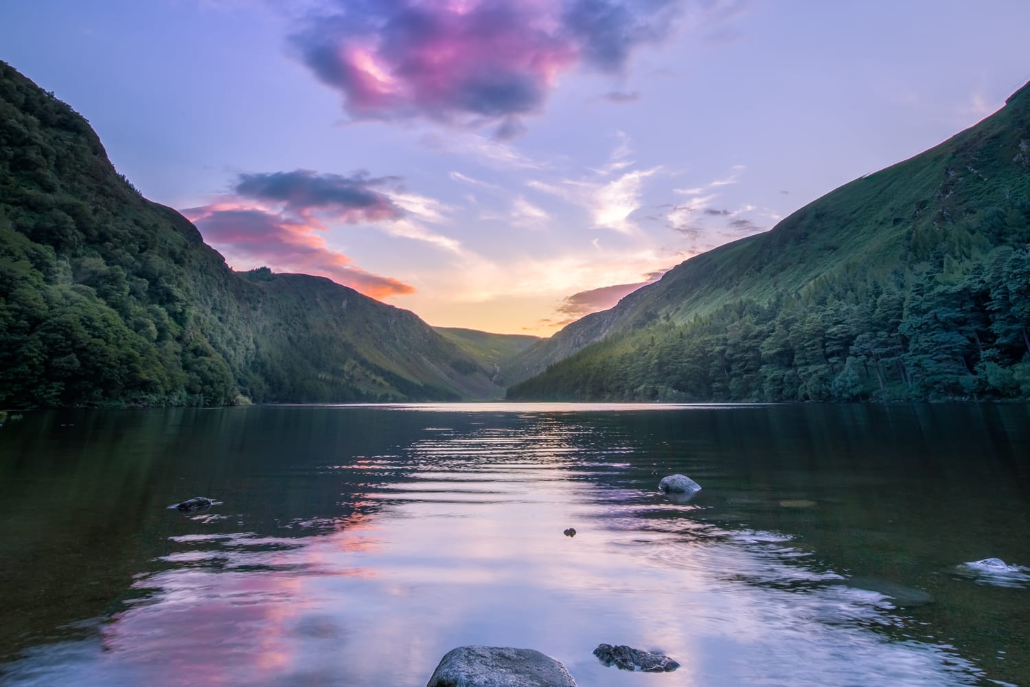 Beautiful reflection of sky in water of Upper Lake in Glendalough Valley in Ireland
