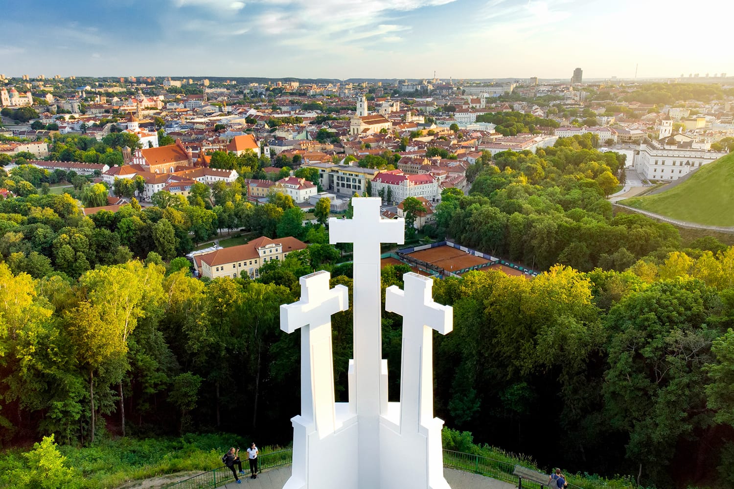 Aerial view of the Three Crosses monument overlooking Vilnius Old Town on sunset. Vilnius landscape from the Hill of Three Crosses, located in Kalnai Park, Lithuania.
