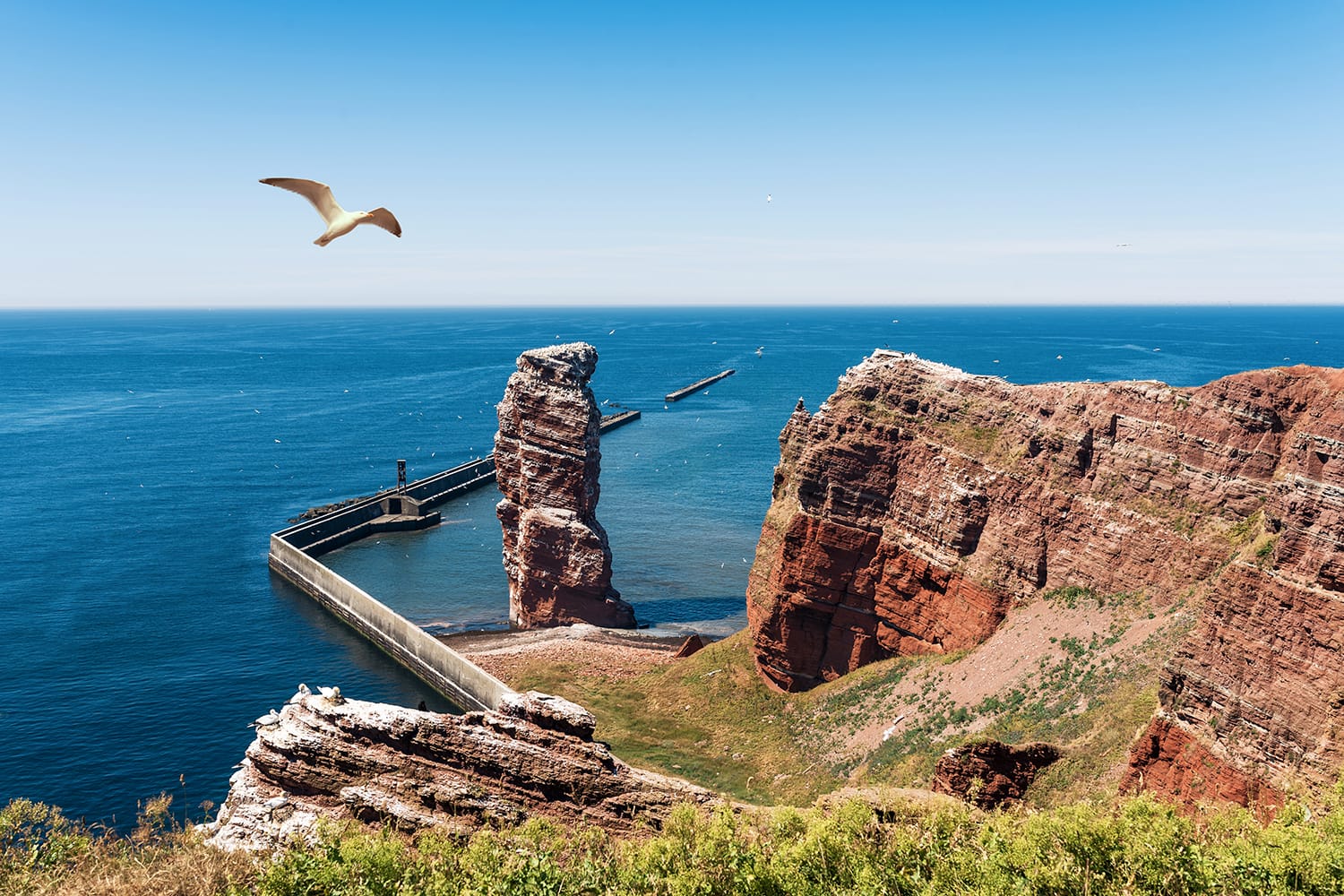 high angle view of Lange Anna sea stack rock on Heligoland island against blue sea and clear sky