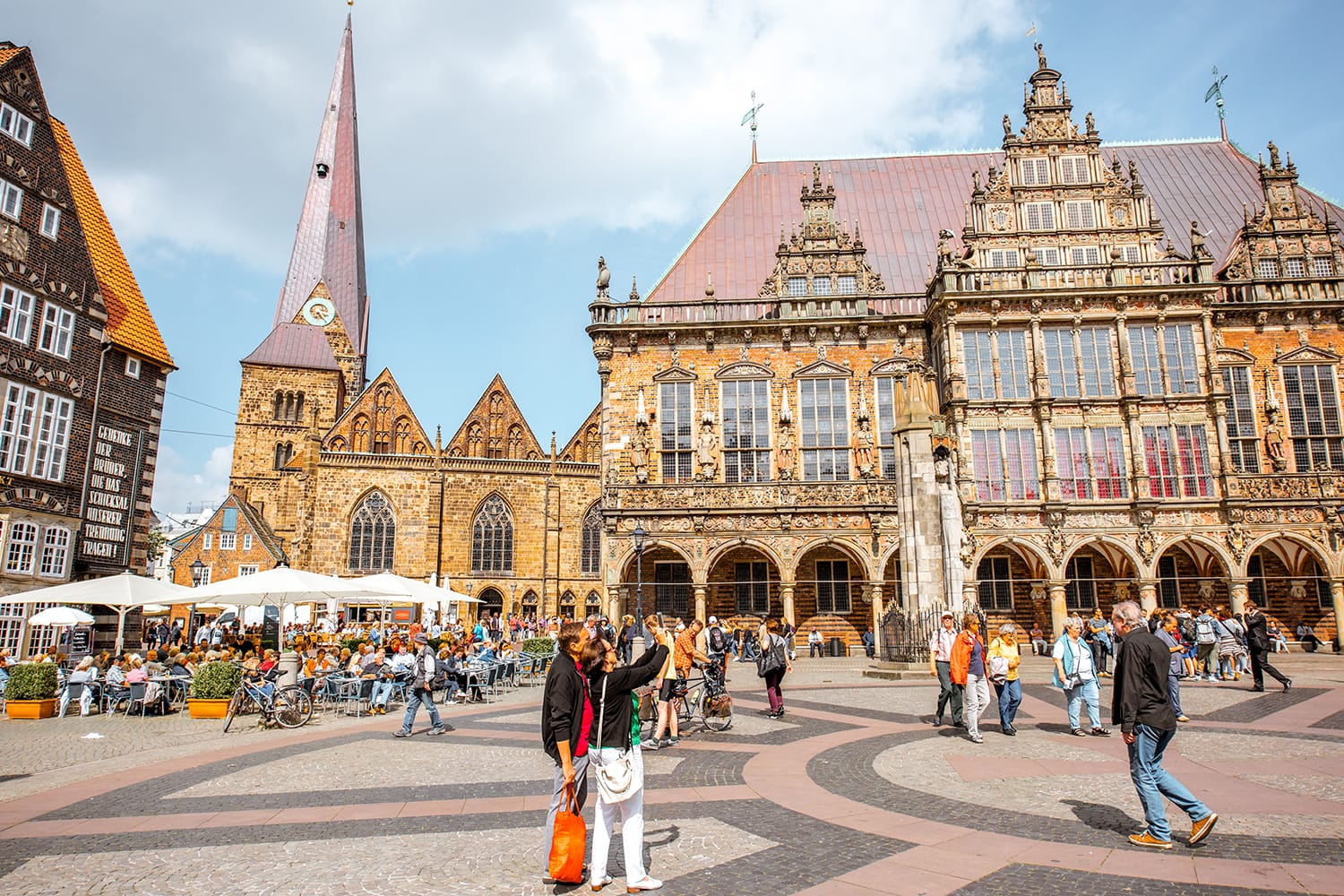 View on the Market square full of tourists with beautiful city hall building during the sunny weather in Bremen, Germany