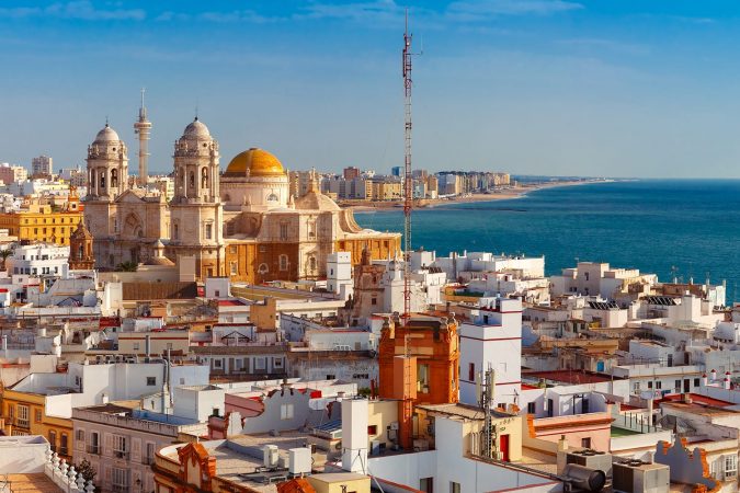 Aerial panoramic view of the old city rooftops and Cathedral de Santa Cruz in the morning from tower Tavira in Cadiz, Andalusia, Spain