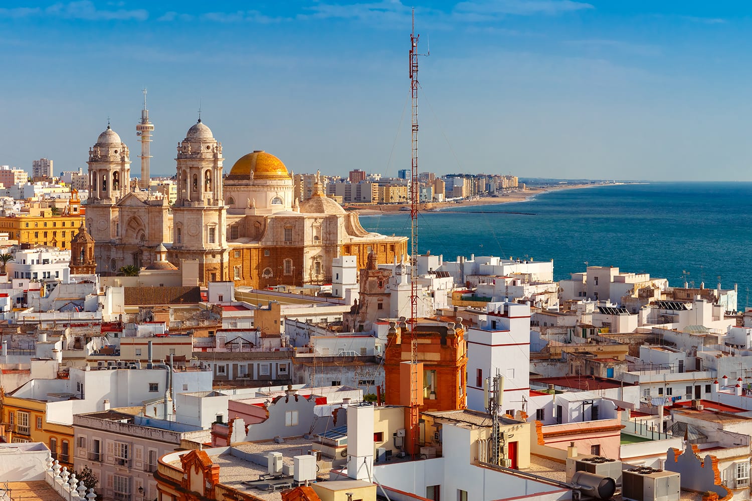 Aerial panoramic view of the old city rooftops and Cathedral de Santa Cruz in the morning from tower Tavira in Cadiz, Andalusia, Spain