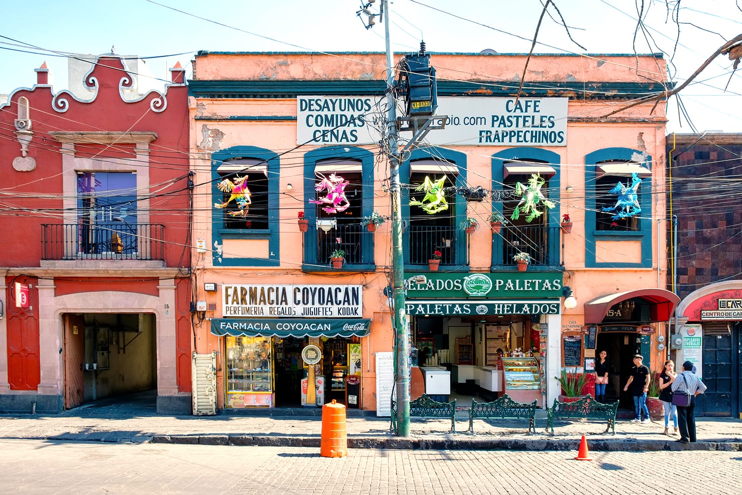 Local businesses at a colorful colonial building in Coyoacan, a historic neighborhhod in Mexico City