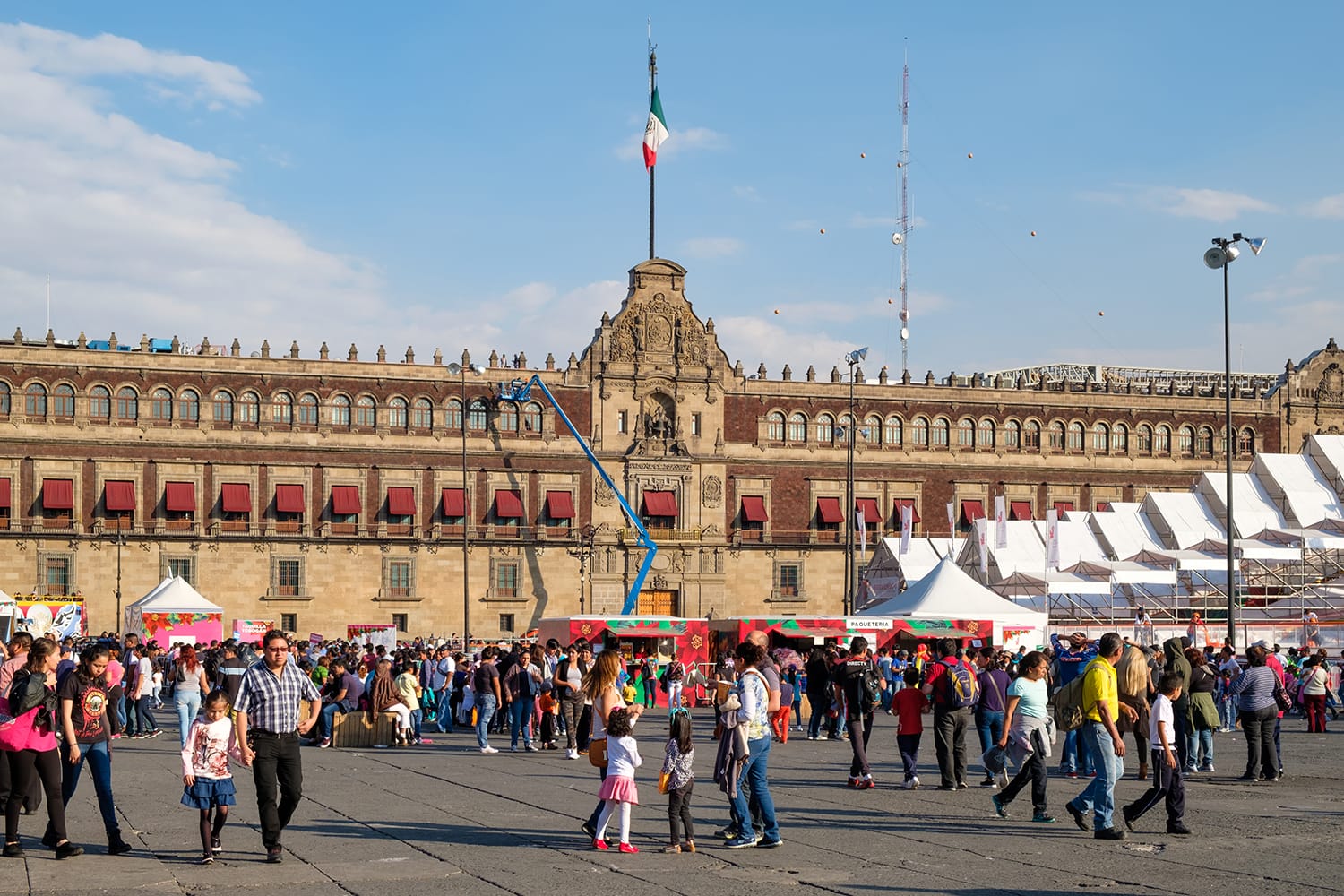 People at El Zocalo in Mexico City with the National Palace
