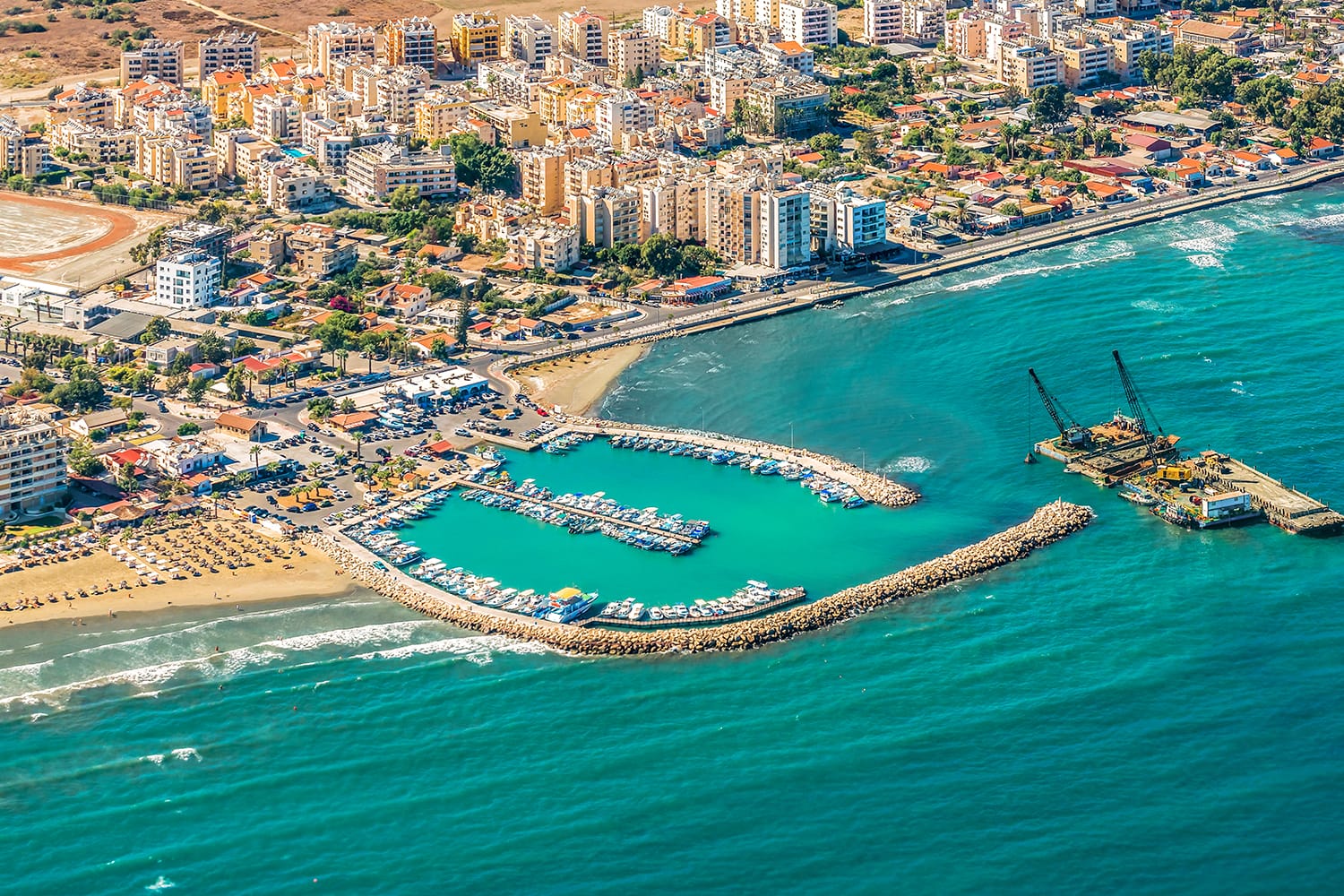 Sea port city of Larnaca, Cyprus. View from the aircraft to the coastline, beaches, seaport and the architecture of the city of Larnaca.